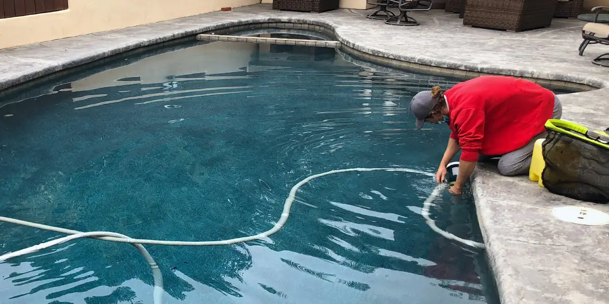 a man analyzing the pool water chemistry in a san diego, ca pool
